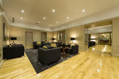 a large living room with couches and a table at Claremont Hotel in Douglas