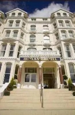 a large white building with stairs in front of it at The Rutland Hotel in Douglas