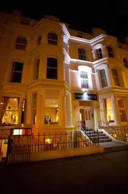 a white building with lights on it at night at The Chesterhouse in Douglas
