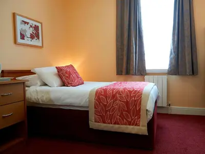 a hotel room with a bed and a window at The Chesterhouse in Douglas