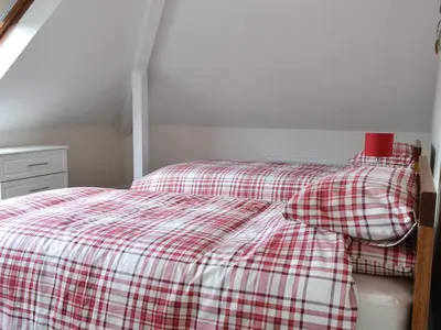 a bedroom with a red and white checkered bed at Crossfeld in Keswick