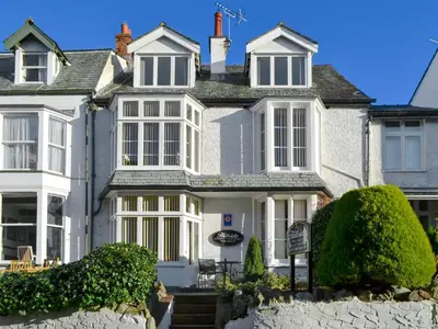 a large white house with white windows at Skiddaw in Keswick