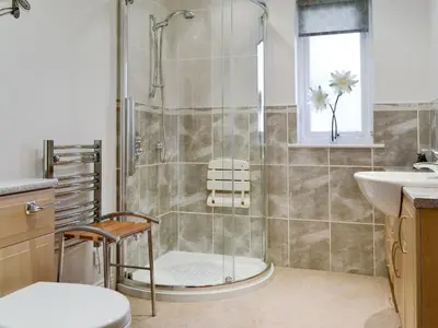 a bathroom with a shower and a toilet and a sink at Cobble Garth in Keswick