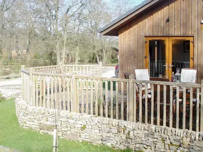 a wooden fence in front of a cabin at Larchwood in Ellonby