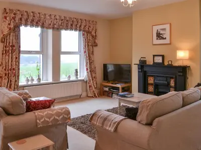 a living room with two couches and a television at Hawthorne House in Bassenthwaite Lake