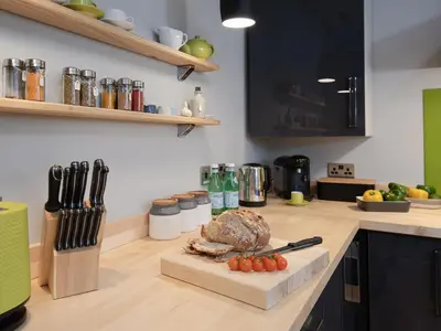 a kitchen counter with a cutting board with a turkey on it at Granary in Gatehouse of Fleet