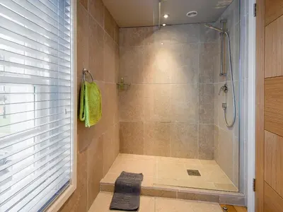 a bathroom with a shower with a glass door at Granary in Gatehouse of Fleet