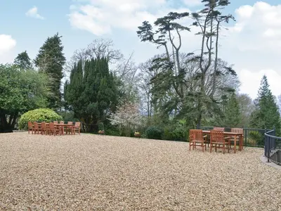 a row of tables and chairs in a park at Blaithwaite House in Blencogo