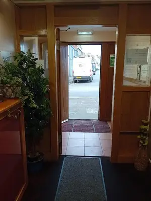 an open door to an office with a van in the street at Quay Head View Aparthotel in Stranraer
