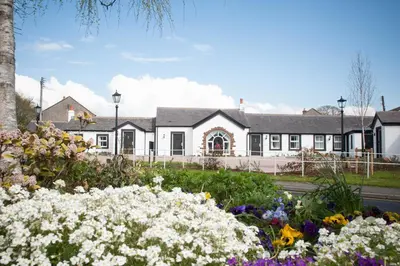 a house with flowers in front of it at Smiths At Gretna Green Hotel in Gretna Green