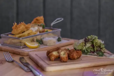 a table with two trays of food and a plate of food at The Lion and The Lamb in Seascale