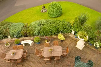 an overhead view of a patio with tables and chairs at The Hill Hotel in Dumfries