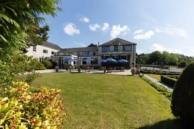 a large house with a lawn in front of it at Lake District Castle Inn Hotel & Spa in Keswick