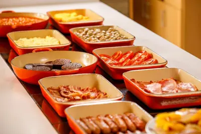 a table topped with trays of different types of food at Holiday Inn Dumfries by IHG in Dumfries