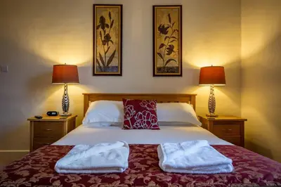a bedroom with a bed with towels on it at Powe House in Keswick