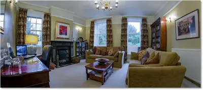a living room filled with furniture and a fireplace at Powe House in Keswick