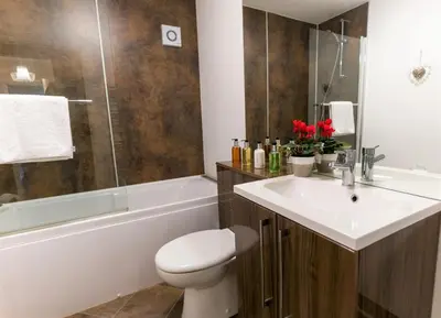 a bathroom with a sink and a toilet and a tub at Wordsworth Apartment Irene court in Cockermouth