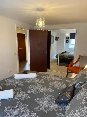 a room with a bed and a living room at Mossie Apartment in Ayr