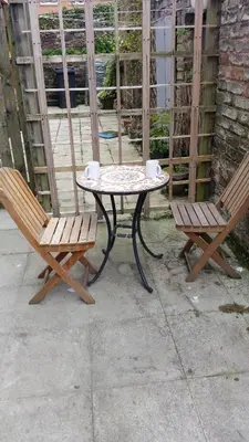 a table and two chairs sitting next to a patio at Central Dumfries in Dumfries