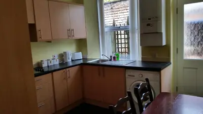 a kitchen with a sink and a table and a window at Central Dumfries in Dumfries