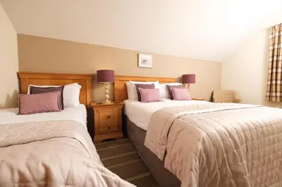 two beds in a hotel room with two beds sidx sidx sidx at The Coledale Inn in Keswick