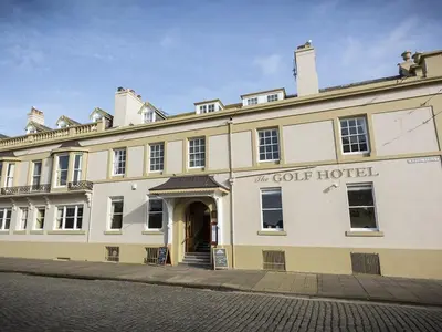 a large white building with the court hotel at The Golf Hotel in Silloth