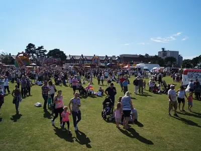 a large crowd of people walking around in a field at The Golf Hotel in Silloth