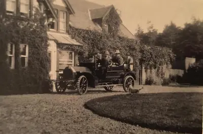 an old photo of a group of people in a car at Lagafater Lodge in Glenwhilly