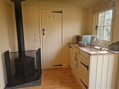 a kitchen with a stove in the middle of a room at Trigony Hotel and Garden Spa in Closeburn