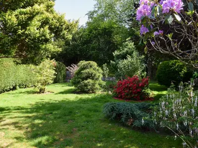 a garden with pink flowers and bushes at Brandelhow in Keswick