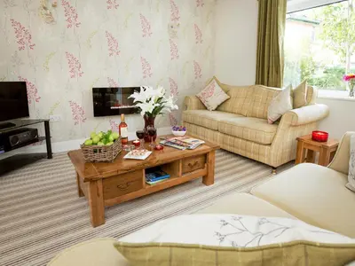 a living room with a couch and a coffee table at Elmcot in Keswick