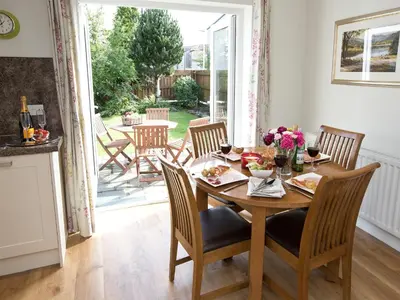 a dining room with a wooden table and chairs at Elmcot in Keswick