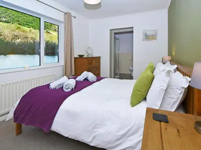 a bedroom with a large bed with towels on it at Holly Bank in Bassenthwaite