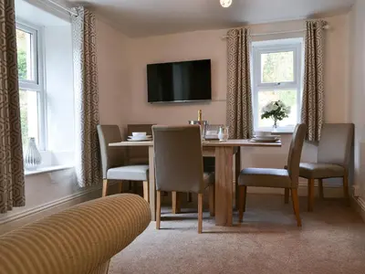 a dining room with a table and chairs at Fairholme in Braithwaite