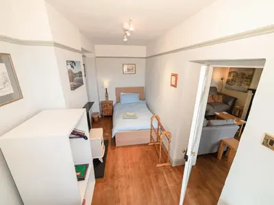 a small room with a bed and a bedroom at Corner House in Lorton
