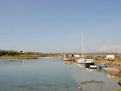 a group of boats docked in a body of water at Mill Street in Drummore