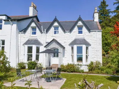 a house with a table and chairs in the yard at Fairview in Rockcliffe