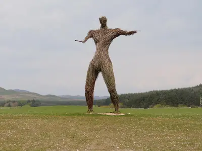 a statue of a man standing in a field at Hameish Holiday Cottage in Kirkcudbright
