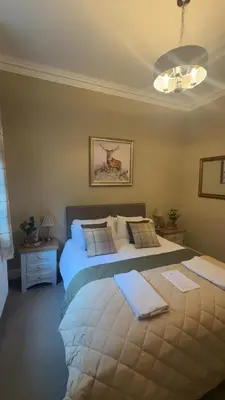 a bedroom with a large bed in a room at The Huntingdon in Dumfries