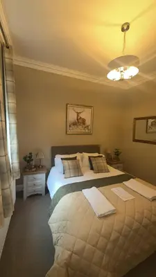 a bedroom with a large bed in a room at The Huntingdon in Dumfries