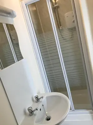 a bathroom with a sink and a mirror at Glenfaba Guest House in Douglas
