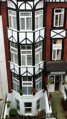 a lego house with a white and black building at Glenfaba Guest House in Douglas