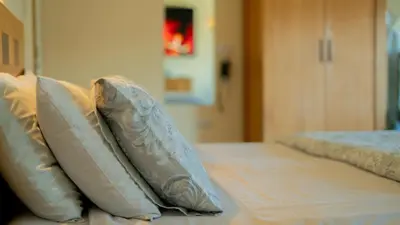 two pillows sitting on top of a bed at Braidmead House in Irvine