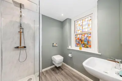 a bathroom with a shower and a toilet and a sink at The Red Admiral Gosforth CA20 1BP in Seascale