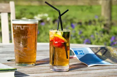 two glasses of drinks sitting on a wooden table at The Traveller's Rest in Grasmere