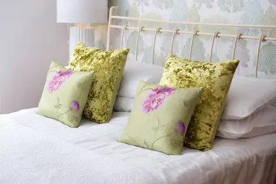 a white bed with four pillows on it at The Traveller's Rest in Grasmere