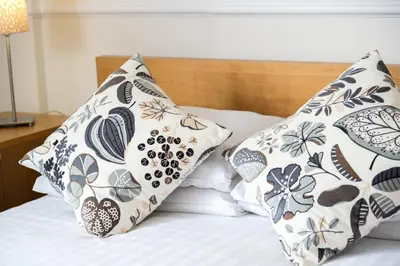 a bed with two pillows on top of it at Balmoral Apartment in Keswick