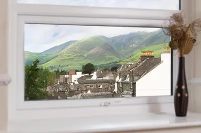 a window with a view of a village at Balmoral Apartment in Keswick