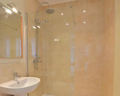 a bathroom with a shower and a sink at Bailey Ground Hotel in Seascale