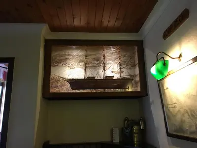a painting of a ship hanging on a wall at The Mariner Hotel in Kippford